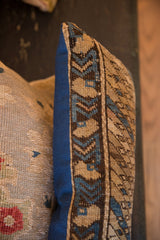 Textured geometric pattern on vintage Caucasian rug pillow, contrasting with its solid blue fabric side.