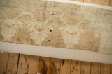 The swappable vintage rug fragment in sandy tones with its black snap system.