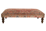 Vintage Persian Rug Ottoman Coffee Table, geometric rusty red, ivory, blue patterns, carved legs.