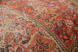 Close-up detail of a late 1930s Persian rug fragment, hand-knotted in red, orange, blue, beige.