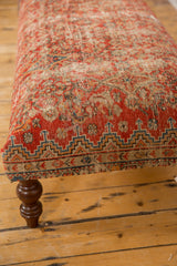 Vintage Persian rug ottoman, geometric red, blue, orange border motif, carved leg.