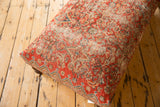 Ottoman end with geometric border in denim blue, tangerine, rusty red; aged ivory background.