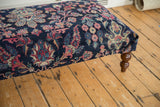 Finely hand-knotted Yezd rug fragment on ottoman, navy field, faded magenta florals.