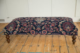 Ornate floral pattern of vintage Yezd rug fragment with faded magenta, ivory, and blue.