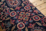 Vintage Yezd hand-knotted rug fragment with traditional navy, faded magenta, ivory, indigo floral pattern.