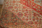 Detail of hand-knotted vintage Senneh rug fragment with red, blue, ivory patterns and color migration.