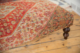Ottoman Coffee Table side view: vintage Persian Senneh rug, showing red-orange, sea blue, ivory, and charcoal patterns.