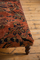 Detail of hand-knotted Lilihan rug fragment, dusty rose with navy floral patterns, curved leg.