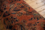 Dusty rose Lilihan rug fragment with navy, gold floral motifs and subtle age wear.