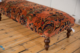 Hand-knotted Lilihan rug fragment, dusty rose and terracotta field with navy floral motifs, visible wear.