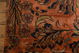 Finely hand-knotted Lilihan rug fragment in dusty rose with navy floral motifs and foundation wear.