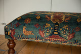 Pictorial chicken motif in sand and cochineal red on a reclaimed antique Persian rug ottoman.