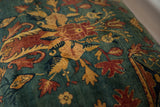 Antique rug ottoman upholstery with red and sand floral details on a sapphire blue field.