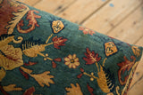 The lush pile of an antique Persian rug features floral and leaf motifs in cochineal red and sand on a sapphire blue field.