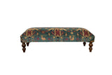 Antique Persian rug ottoman with pictorial chickens in sapphire blue and red, set on dark curved legs.