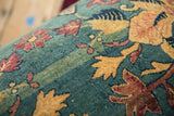 Detailed texture of a 1920s Persian rug with sand and red motifs on a sapphire blue pile.