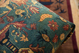 Close-up of the antique rug ottoman's corner, detailing floral and chicken motifs on a sapphire field.