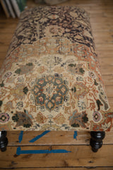 Close view of the vintage Mahal rug ottoman's textured, worn pile and teal floral pattern.