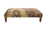 Antique Persian Kerman rug ottoman table with sand, aubergine, pistachio, blue floral patterns.