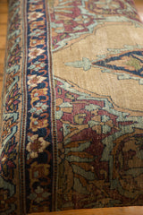 Antique Persian Kerman rug ottoman features deep blue border, sand and aubergine floral motifs.