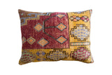 Vintage Oushak rug fragment pillow with vibrant geometric design in rich red and golden yellow.