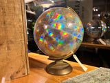 Vintage 12 inch Replogle Prism holographic world globe reflecting vibrant rainbow colors.
