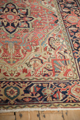 Angled view of a vintage Heriz rug showing the Samovar border and ornate floral field.