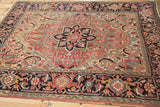 Angled view of a vintage Persian Heriz rug's gem-toned medallion and wide Samovar border.