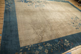 Vintage Peking carpet showing sapphire blue border with floral motifs and antique ivory field.