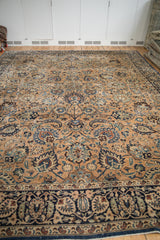 Vintage Meshed carpet's Shah Abas palmettes with bronze, navy, and sky blue tones.