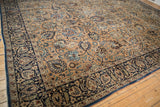 Vintage Meshed carpet corner with navy blue border, bronze field, and Shah Abas floral palmettes.