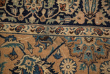 Vintage Meshed rug detail with Shah Abas palmettes, vinery, and border in sand, copper, and navy.