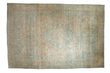 Vintage distressed Persian Khoy carpet with a floral center medallion in a soft palette of dusty apricot, ivory, and pale sky blue.
