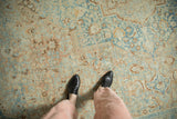Evenly worn pile of a distressed Khoy carpet with dusty apricot and pale sky blue floral motifs.