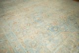 Time-softened pile of a distressed vintage Khoy carpet with apricot and pale blue floral motifs.