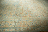 A low-angle view across the vintage Khoy carpet's surface showing its low-pile, distressed texture.