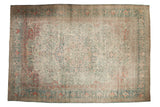 A large distressed vintage Mahal carpet with an allover floral design in dusty jade green, faded red, and soft ivory.