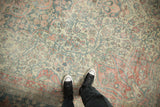 Softly faded floral patterns on the low, distressed pile of a vintage Mahal carpet.