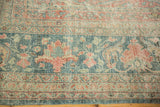 Worn pile on a Persian Mahal's floral border in dusty blue, jade green, and ruby red.