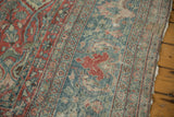 Exposed knot heads and low pile texture on a distressed vintage Mahal carpet in dusty blue and red.