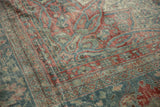 Storied texture and visible knot heads on the corner of a distressed Mahal carpet.