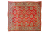 Antique Oushak square carpet with repeating shadow medallions in red and oxidized silver.
