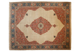 Vintage Bulgarian Tabriz carpet with a central medallion, dusty blush spandrels, and navy border over an ivory field.