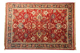 Vintage Agra carpet with oversized palmettes and cloudbands on a cherry red field and a dark navy border.