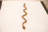 Vintage Iron Snake collectible, displaying its lower body and textured rust-brown patina.