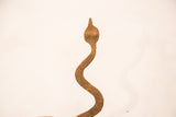 Close-up of vintage Lobi iron snake head, showing unique handmade form and aged rust patina.