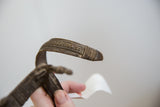Close-up view of the etched textural patterns on the vintage African bronze snake bracelet.