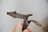 Detailed casting on the stylized head of the African bronze wrist snake.