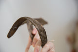Detailed cast pattern and aged patina on the vintage African bronze bracelet.