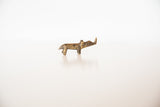 Side profile of a vintage mini bronze rhino showing its rustic, aged patina.